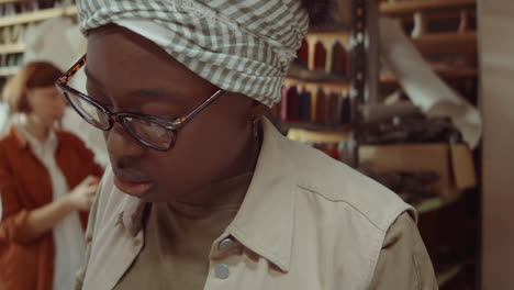 African-American-Woman-Cutting-Leather-in-Shoemaker-Workshop